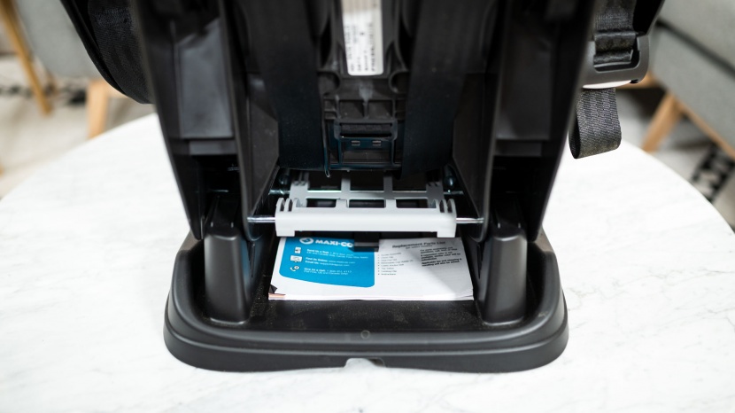 the user manual for the maxi-cosi is under the chair on top of the...