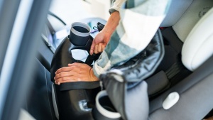 You need to remove the seat fabric of the Maxi-Cosi to gain access...