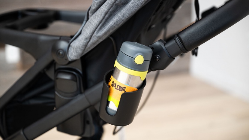 the modes has a side cup holder that snaps onto the frame.