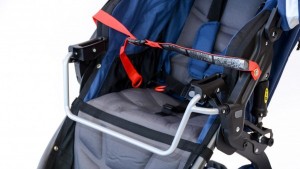 This image shows a car seat adapter with a secondary strap setup...