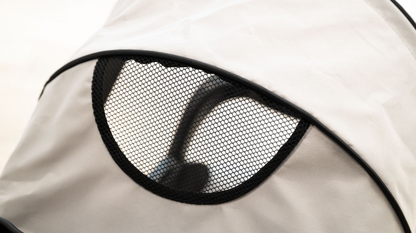 the kolcraft has a smaller peek-a-boo window with no cover, so...