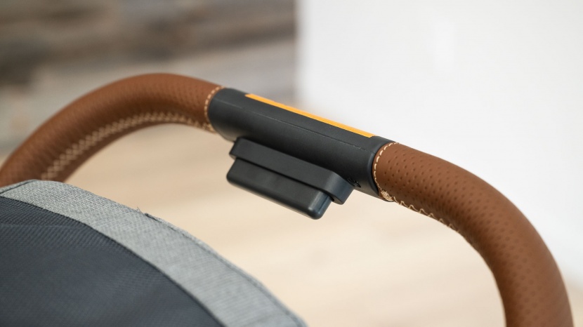 the minu v2 fold is initiated by squeezing the button located on the...