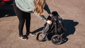 The Britax folds in half by way of a pull handle in the center of...