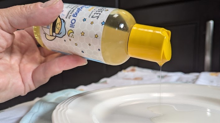 zarbees has a thinner consistency that flows easily from the cap.