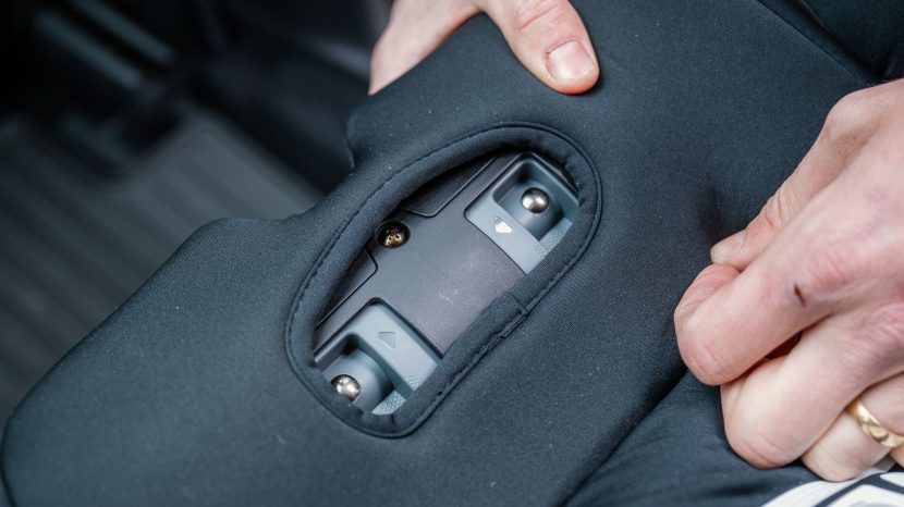 the mechanism to open the clicktight belt path is on the seat bottom...