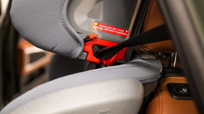 the grow with you shoulder guide positioner is colored red and has...