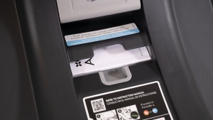 The Aria user manual is tucked into the slot on the top of the base.