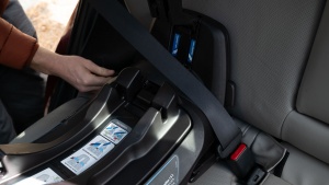 Threading the vehicle belt through the Nuna base lock-off is one of...