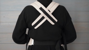 The shoulder straps on the Momcozy crisscross on your back.