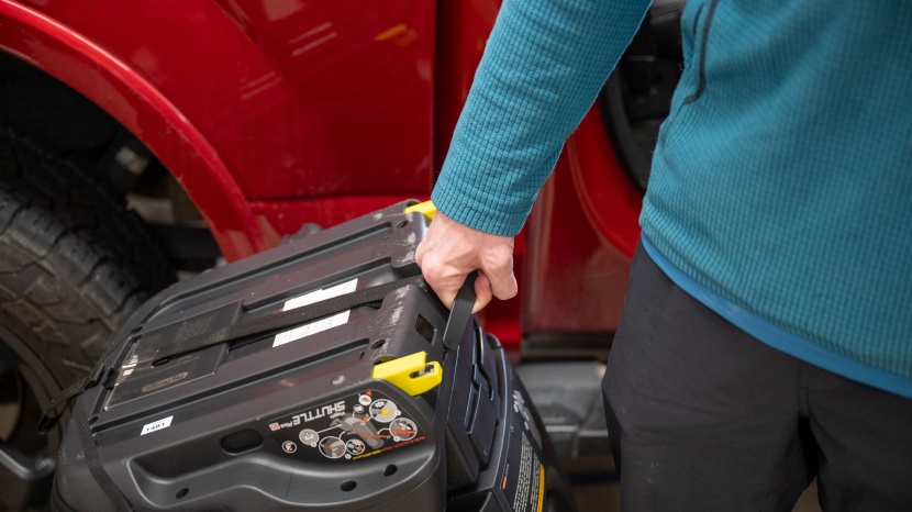 the bottom of the shuttle plus seat has a handle for carrying.