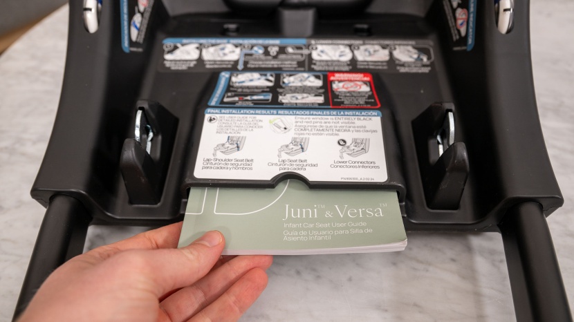 the juni manual stores in a slide pocket on the top side of the base.