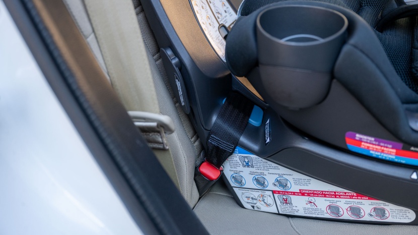 the cybex latch connector strap slides behind the lock off in a...