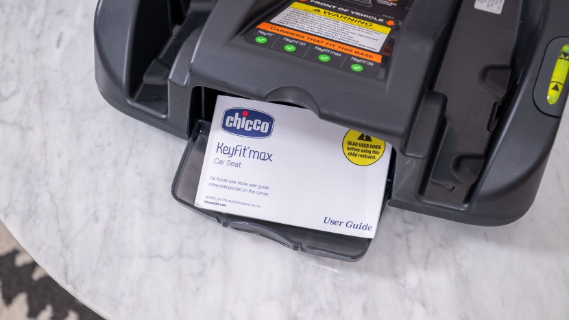 the max's manual stows in a dedicated pocket in the base.